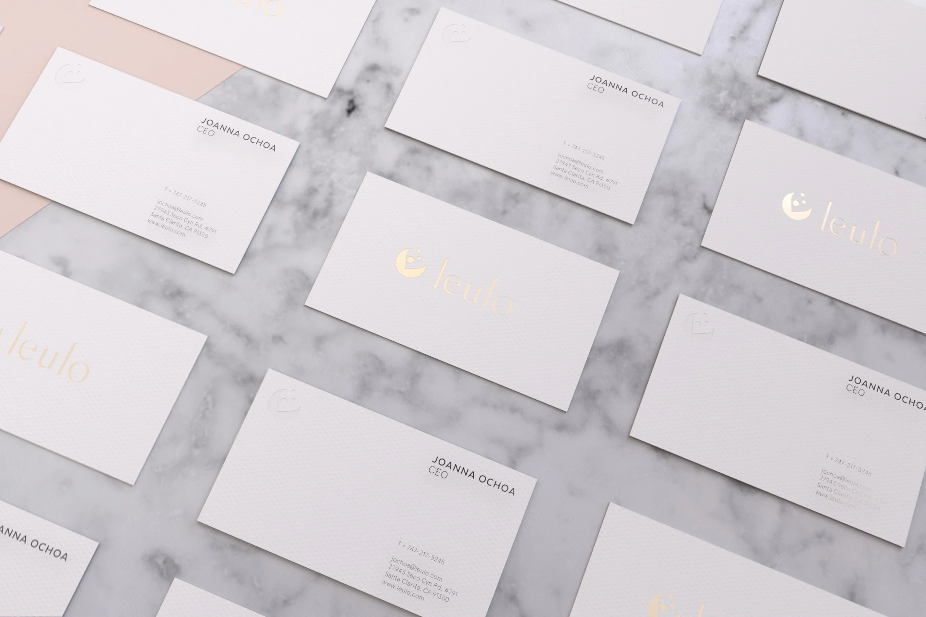 Leulo business cards with gold foil logo on marble