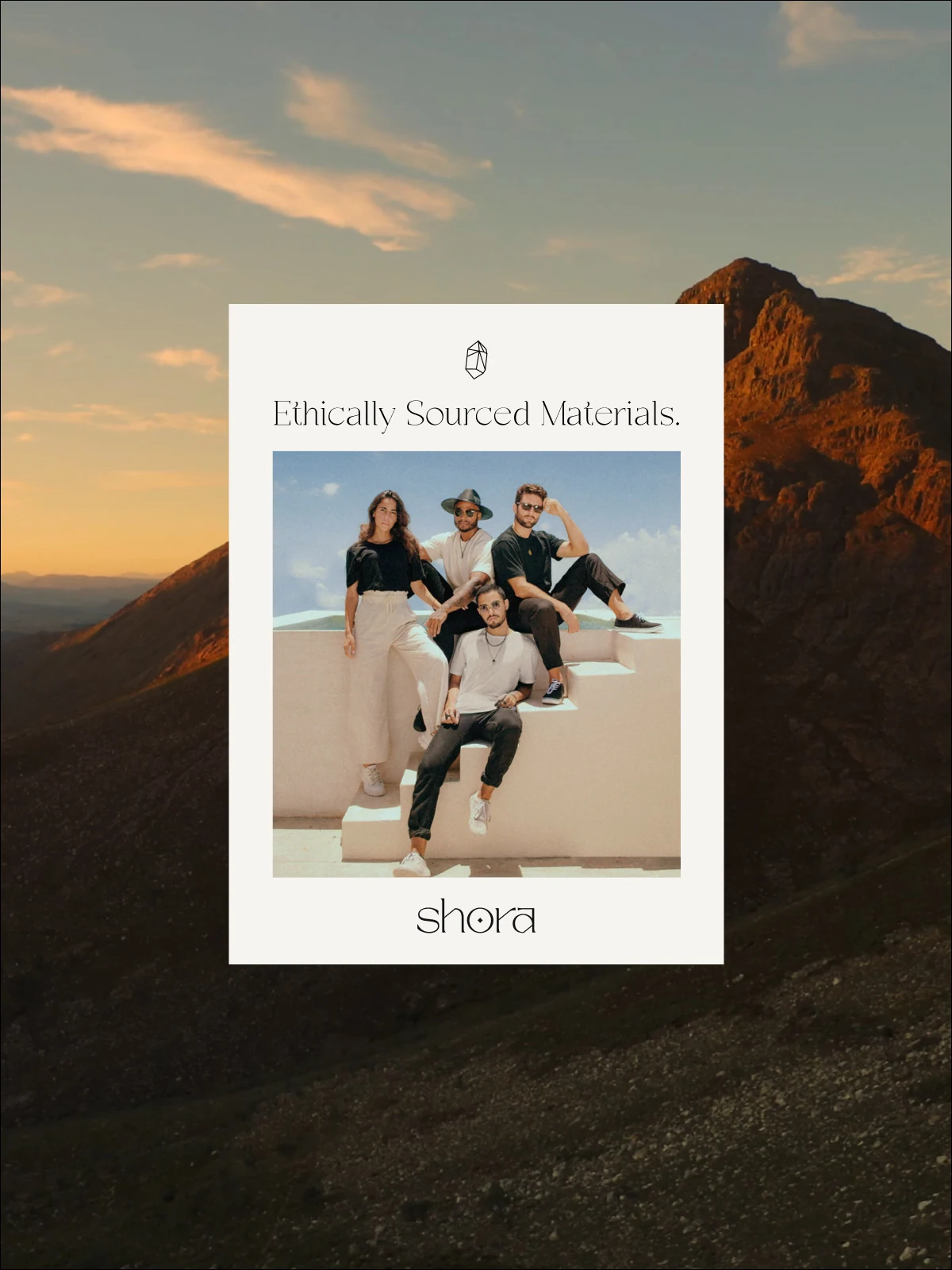 Shora poster “Ethically Sourced Materials” against a mountain sunset