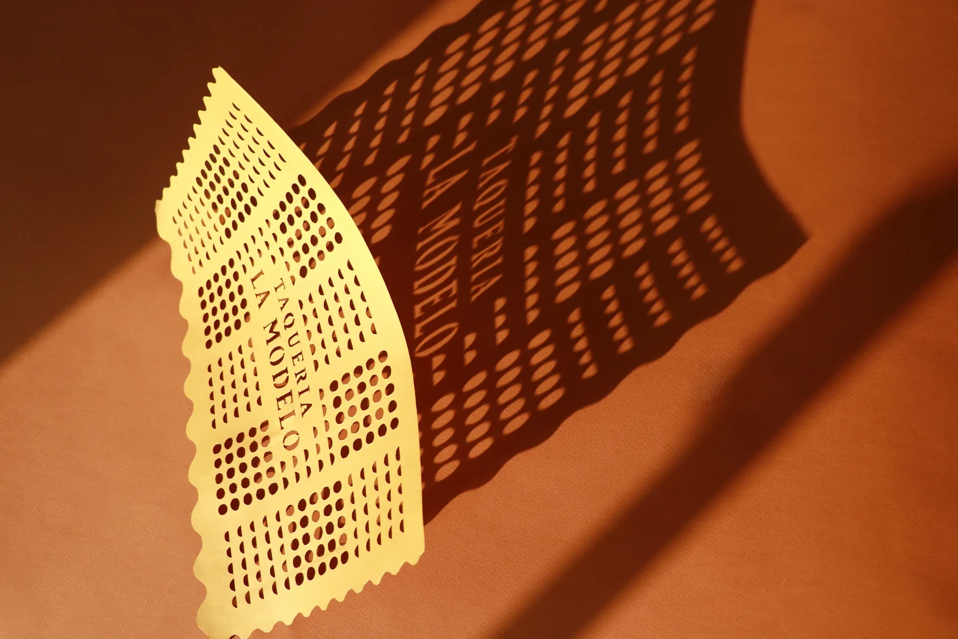 Taquería La Modelo papel picado casting a patterned shadow