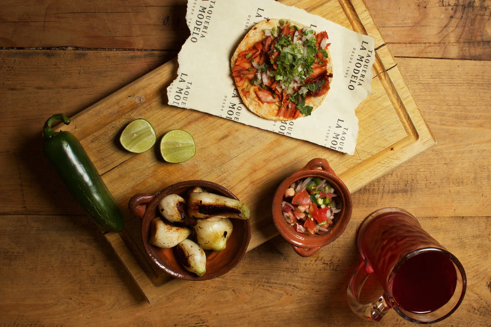 Tacos, salsa and limes served on Taquería La Modelo branded paper